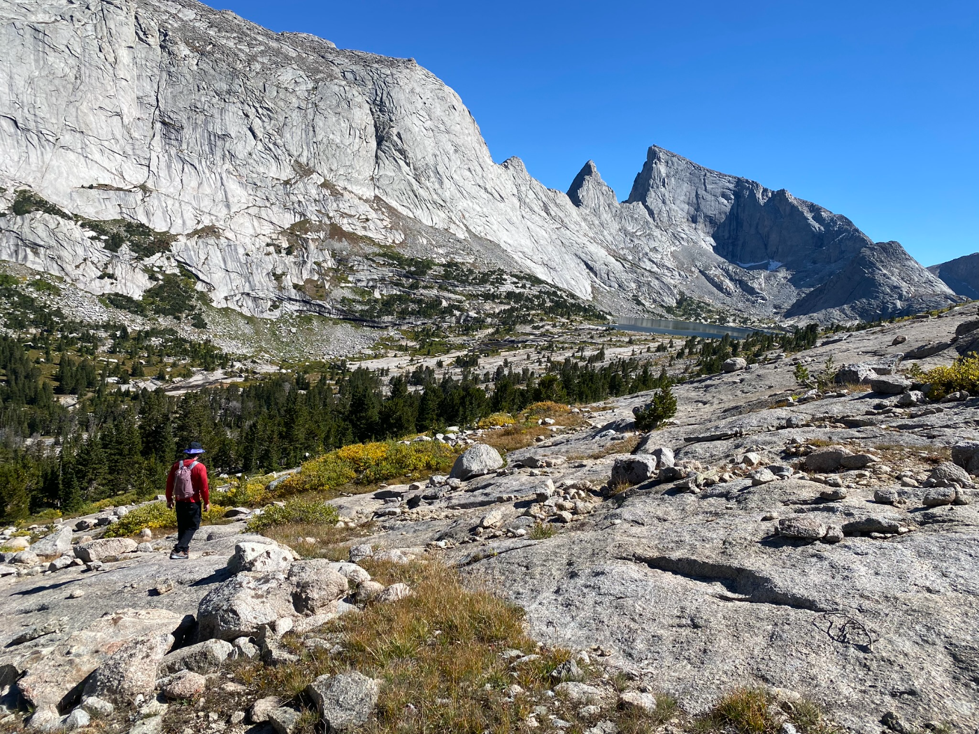 A backpacker carrying a heavy load across alpine terrain