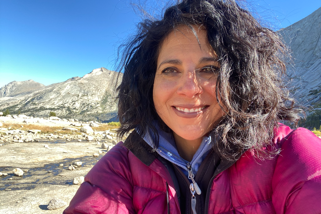 A smiling adventurer enjoying a day out in the mountains